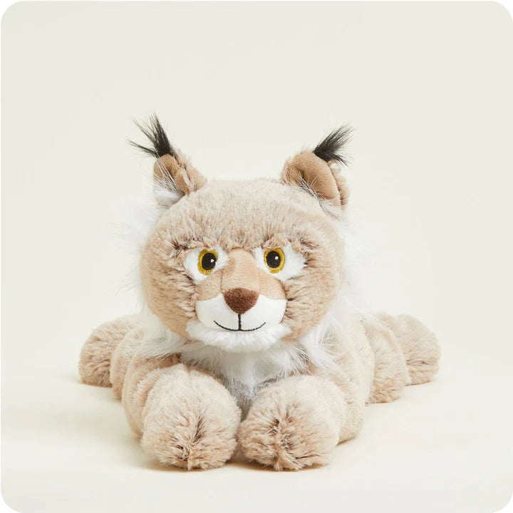 A soft, plush bobcat toy with spotted fur and tufted ears, designed to be microwavable.