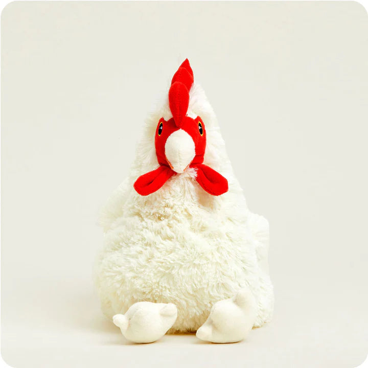 A soft, plush chicken toy with a white body and red comb, designed to be microwavable.