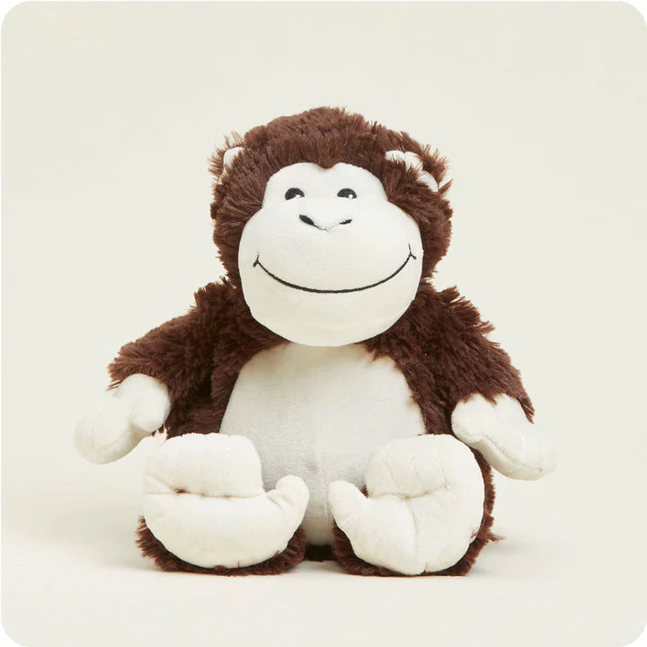 A soft, brown plush monkey toy with a long tail and a friendly face, designed to be microwavable.