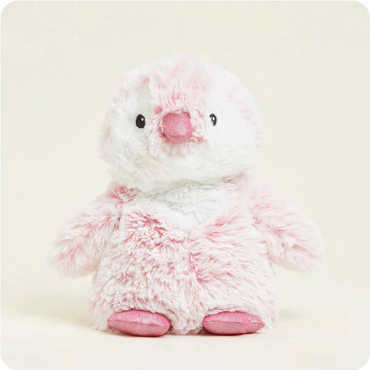 A soft, plush penguin toy that is primarily pink with a white belly, designed to be microwavable.
