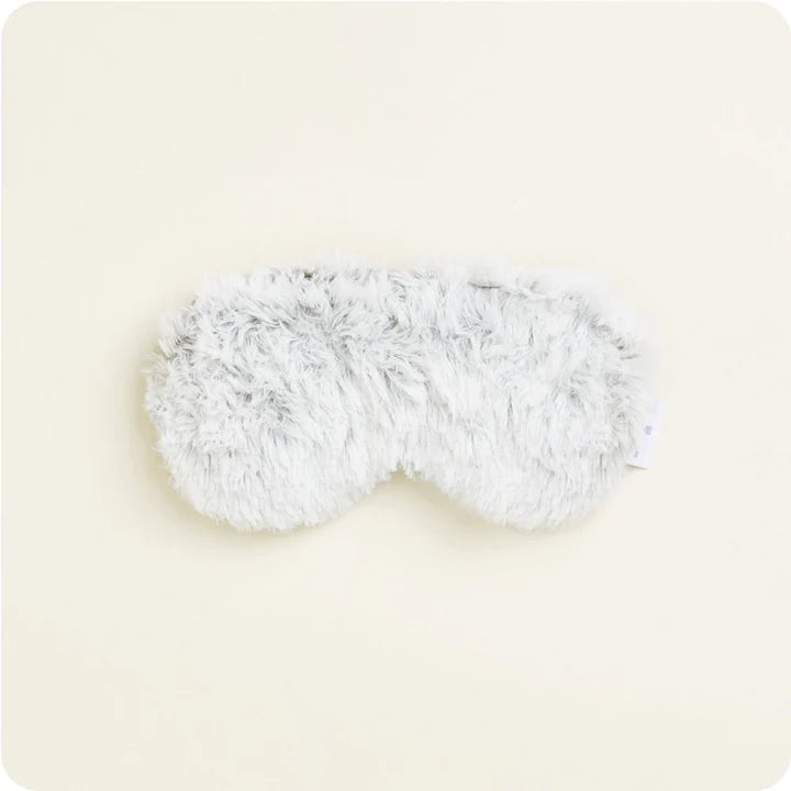 A soft, plush gray eye mask with a satin elastic strap, designed to be microwavable.