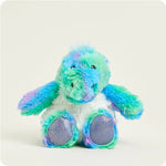 A small, soft plush dinosaur toy with a vibrant rainbow color pattern, designed to be microwavable.