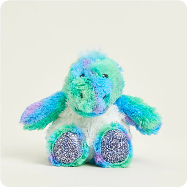 A small, soft plush dinosaur toy with a vibrant rainbow color pattern, designed to be microwavable.