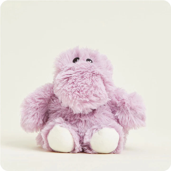 A small, soft plush hippopotamus toy, light purple with a friendly face, designed to be microwavable