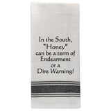White tea towel with black trim and funny Southern honey quote.