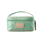A mint colored Jon Hart mini makeup case with natural leather trim and a leather patch for personalization.