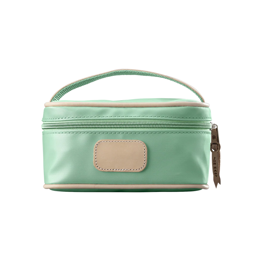 A mint colored Jon Hart mini makeup case with natural leather trim and a leather patch for personalization.