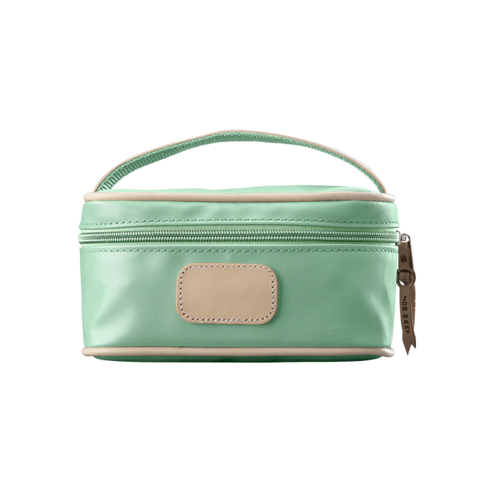 A mint colored Jon Hart mini makeup case with natural leather trim and a leather patch for personalization.