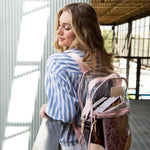 Clear Jon Hart backpack made of durable 20- and 30-mil PVC with Natural Leather trim, front zip pocket, reinforced corners, and adjustable leather-padded straps — stylish and meets clear bag requirements