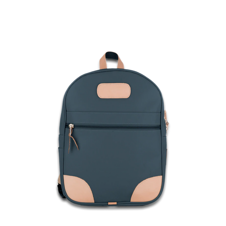 Jon Hart french blue coated canvas backpack with Natural Leather trim, front zip pocket, two side pockets, and adjustable leather-detailed straps.